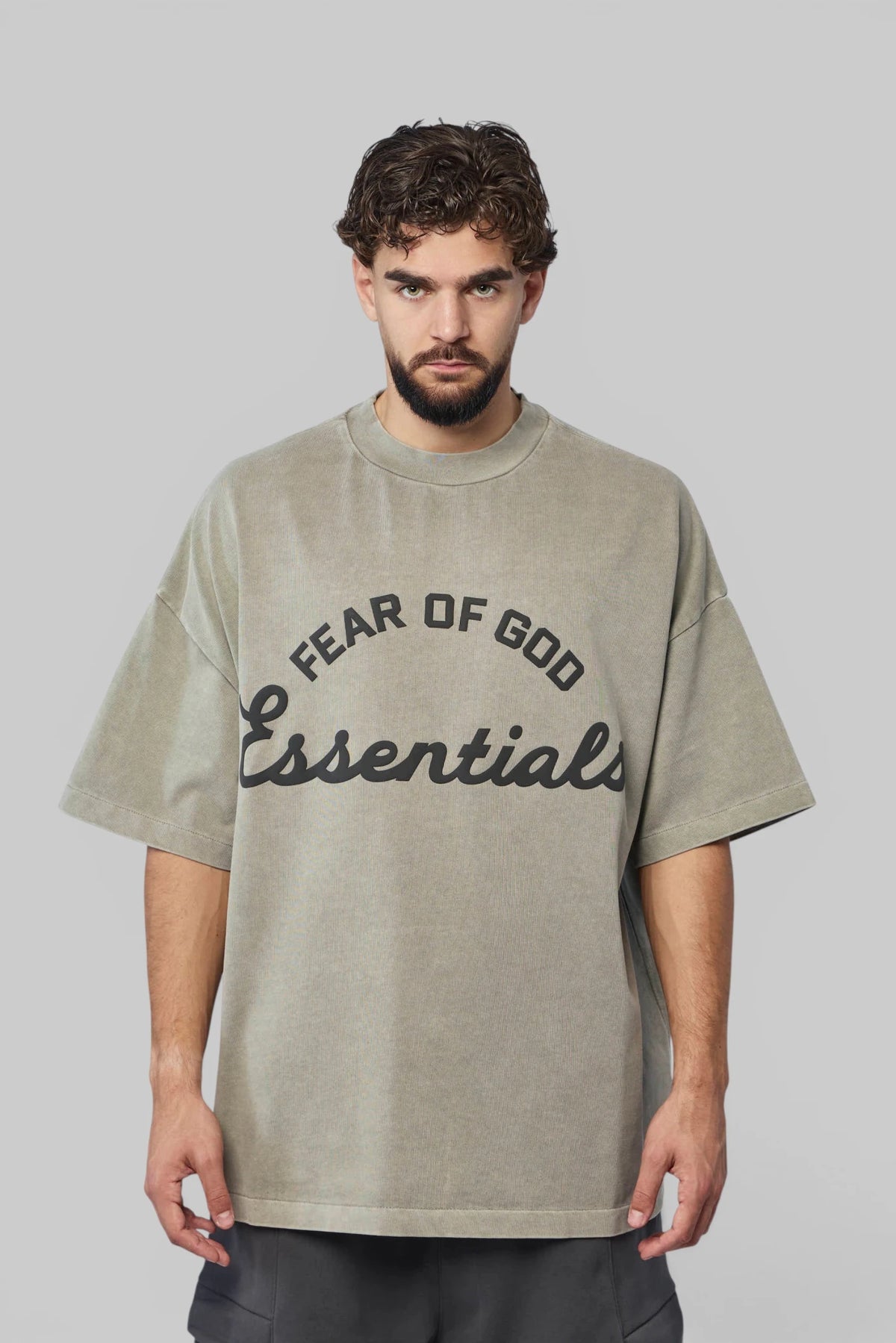 Close-up of bold front text print on Fear Of God Essentials tee