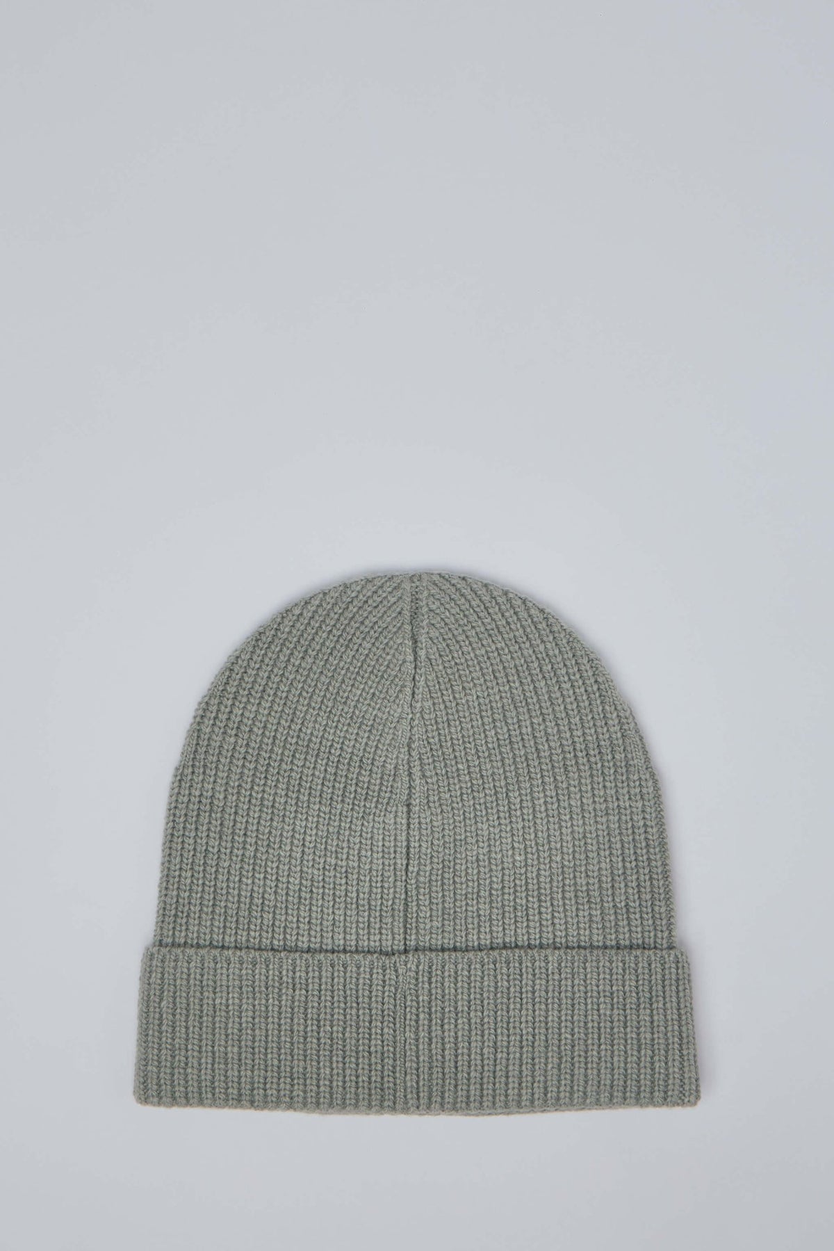 Close-up view of Fear of God beanie showing turned-up cuff and minimalist logo detail