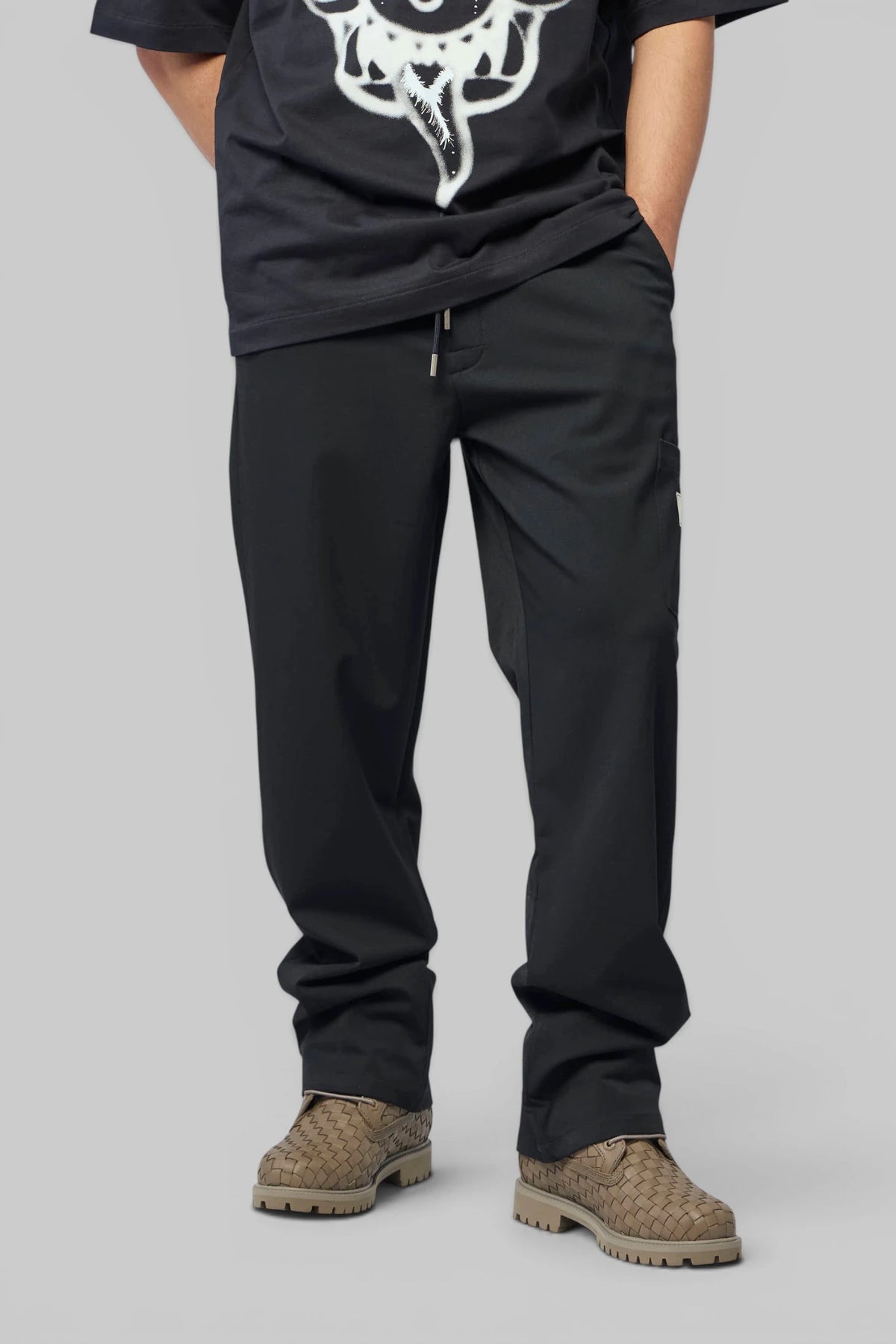 FLÂNEUR Cargo Pants in black with drawstring waist, front view