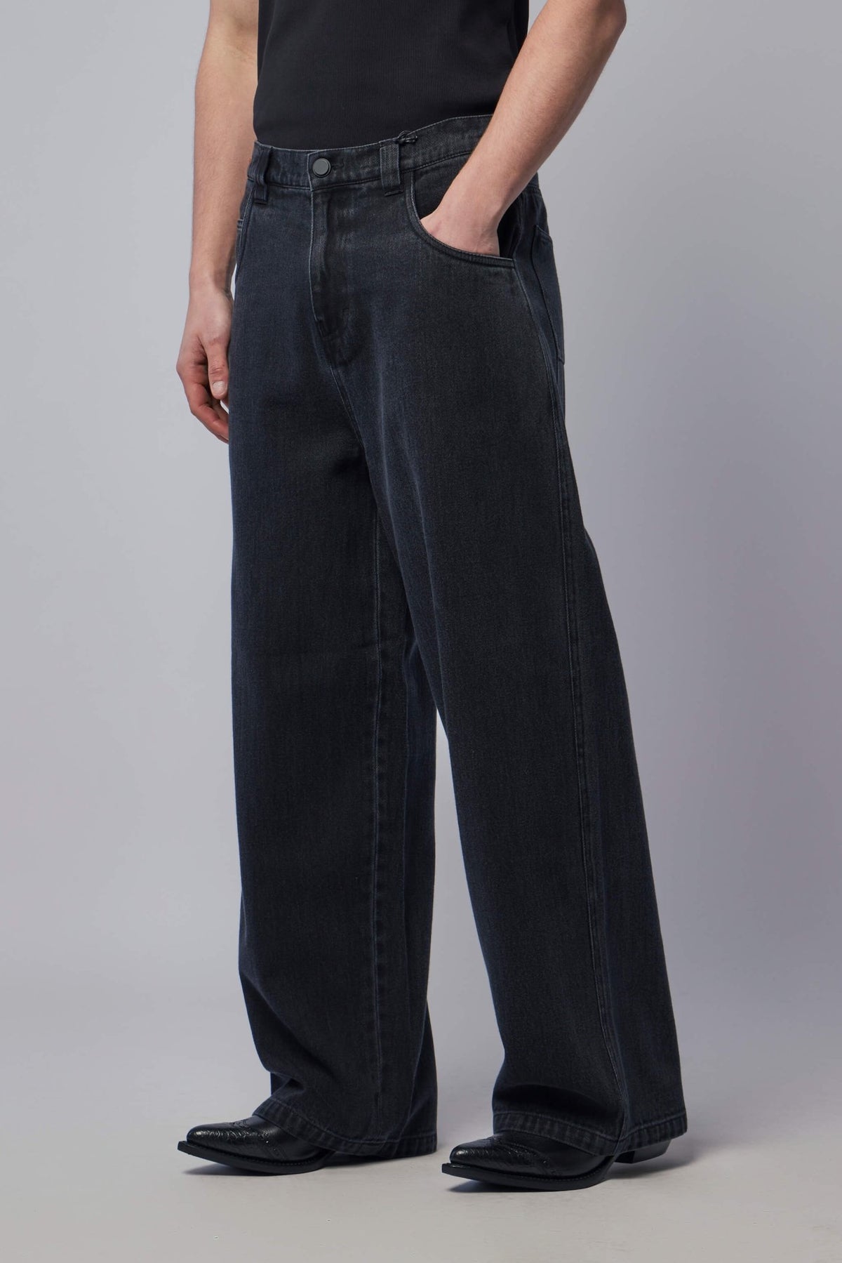 Model wearing FREI-MUT wide-leg jeans showing relaxed silhouette