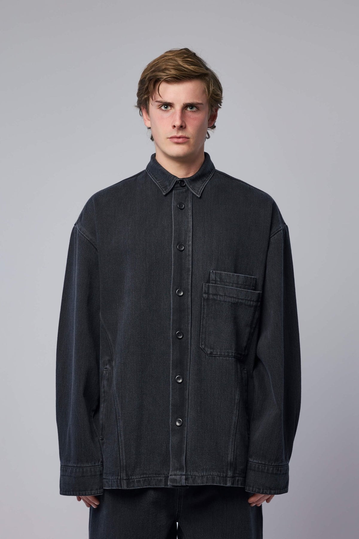 Close-up of premium selvage denim texture and button details on FREI-MUT jacket