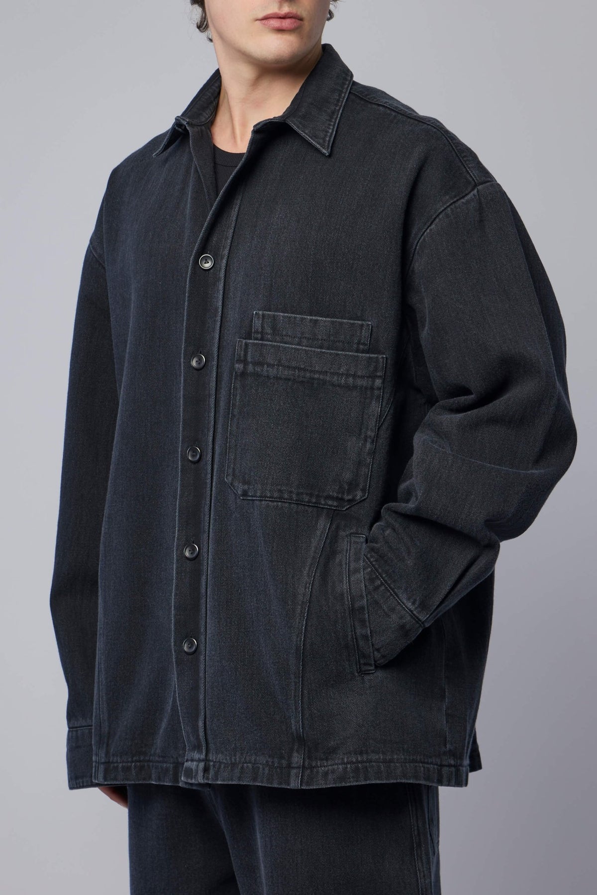 Model wearing FREI-MUT blue denim jacket styled casually