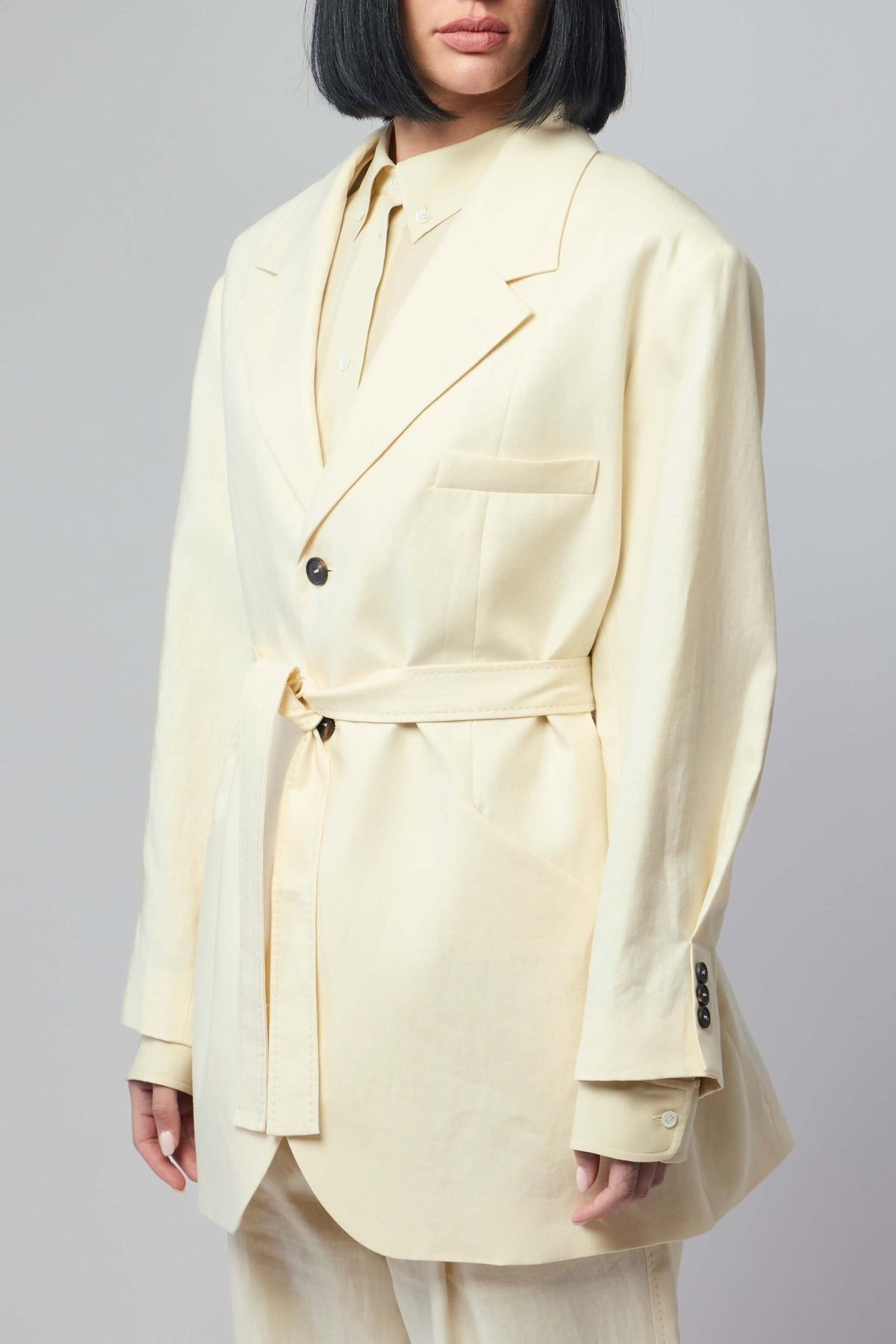 Model wearing Frenken ivory linen wrap blazer, demonstrating the relaxed yet refined fit