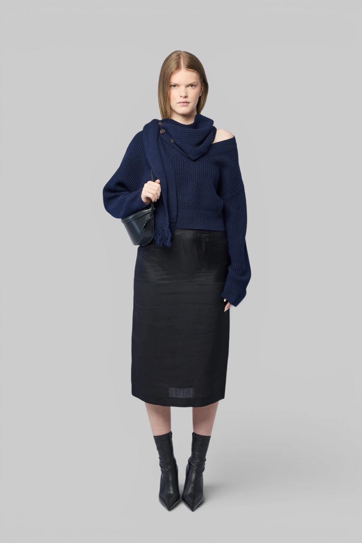 Close-up of asymmetrical collar and decorative buttons on Frenken jumper