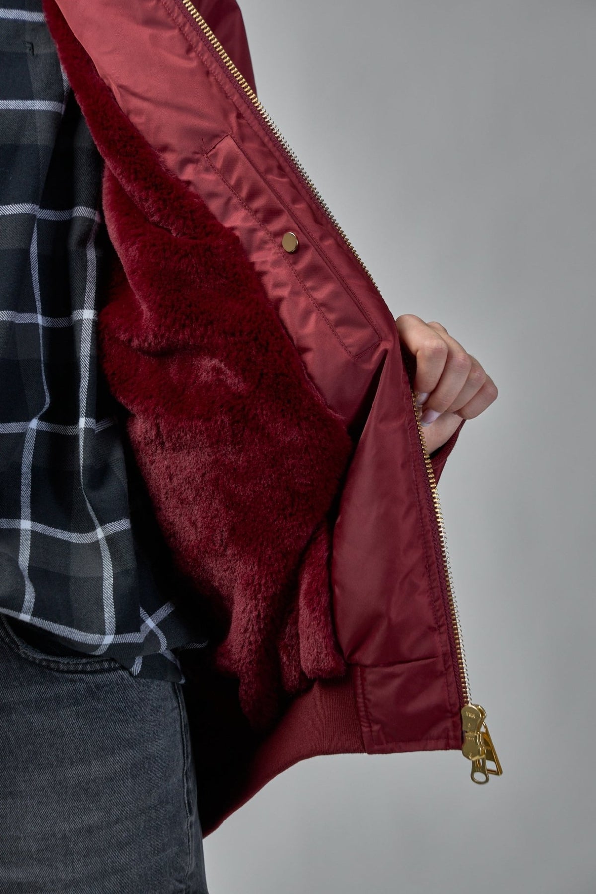 Detail shot of zipped hand pockets and shiny nylon finish