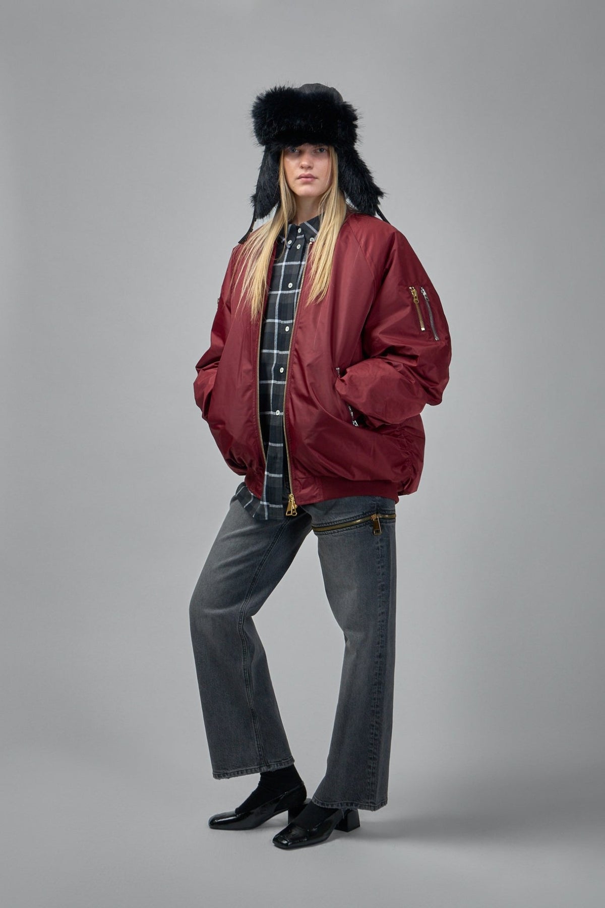 Full outfit styling with burgundy bomber jacket layered over basics