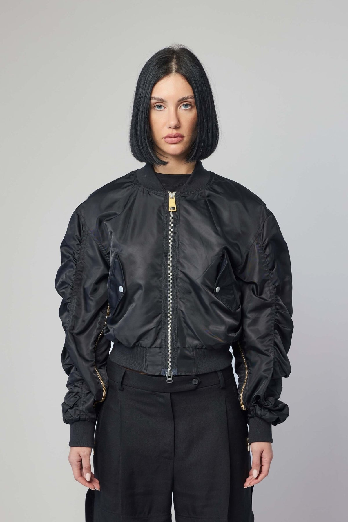 Close-up of premium zip detail on black bomber jacket