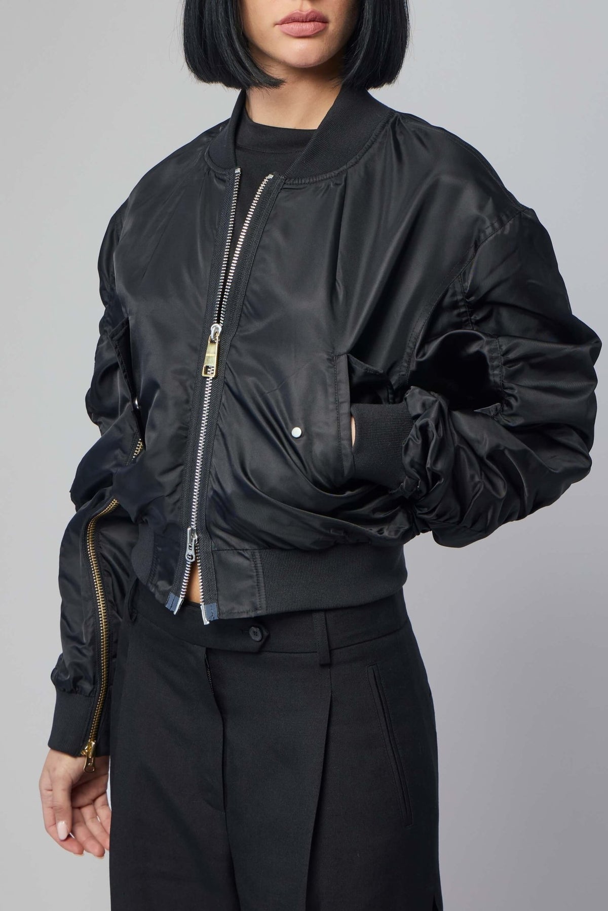 Model wearing Frenken black zip bomber jacket styled casually