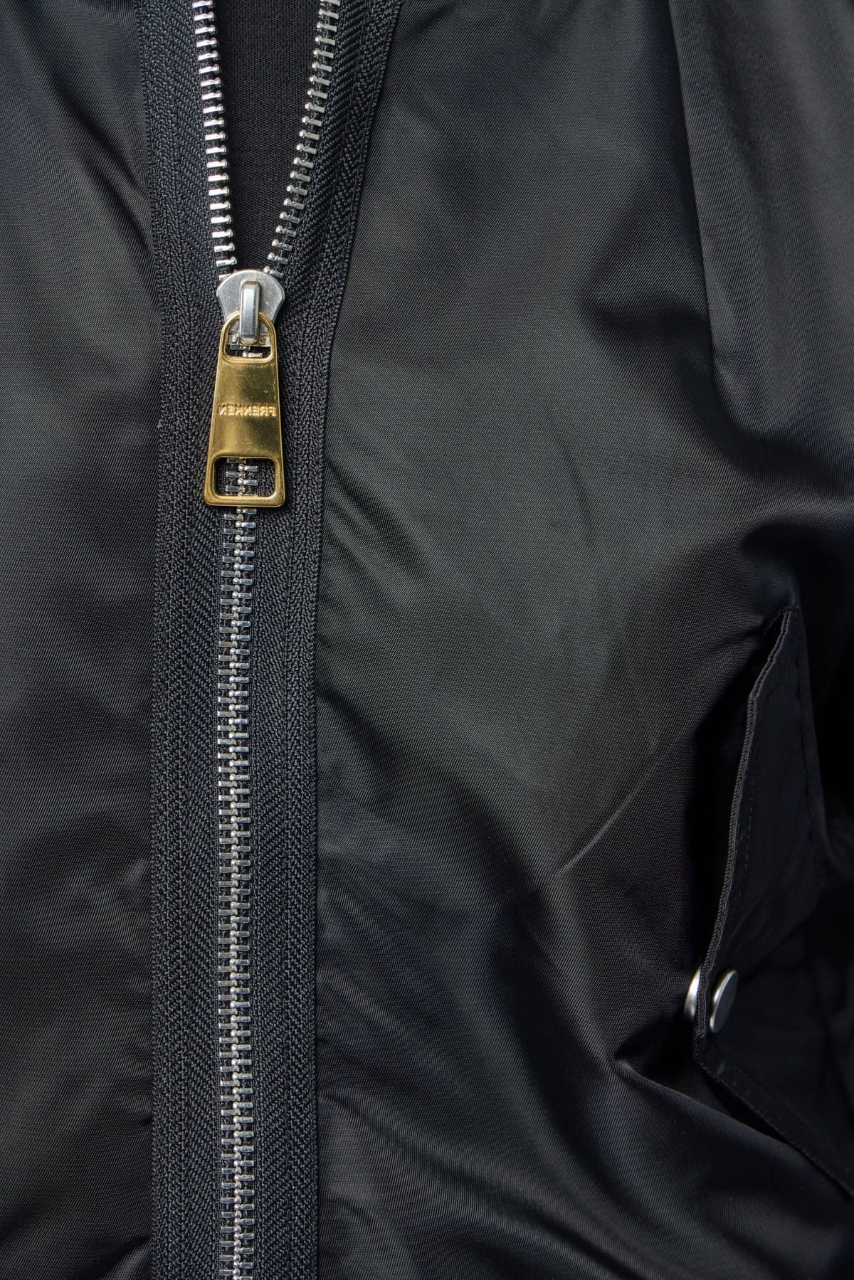 Back view of sleek black nylon bomber jacket design
