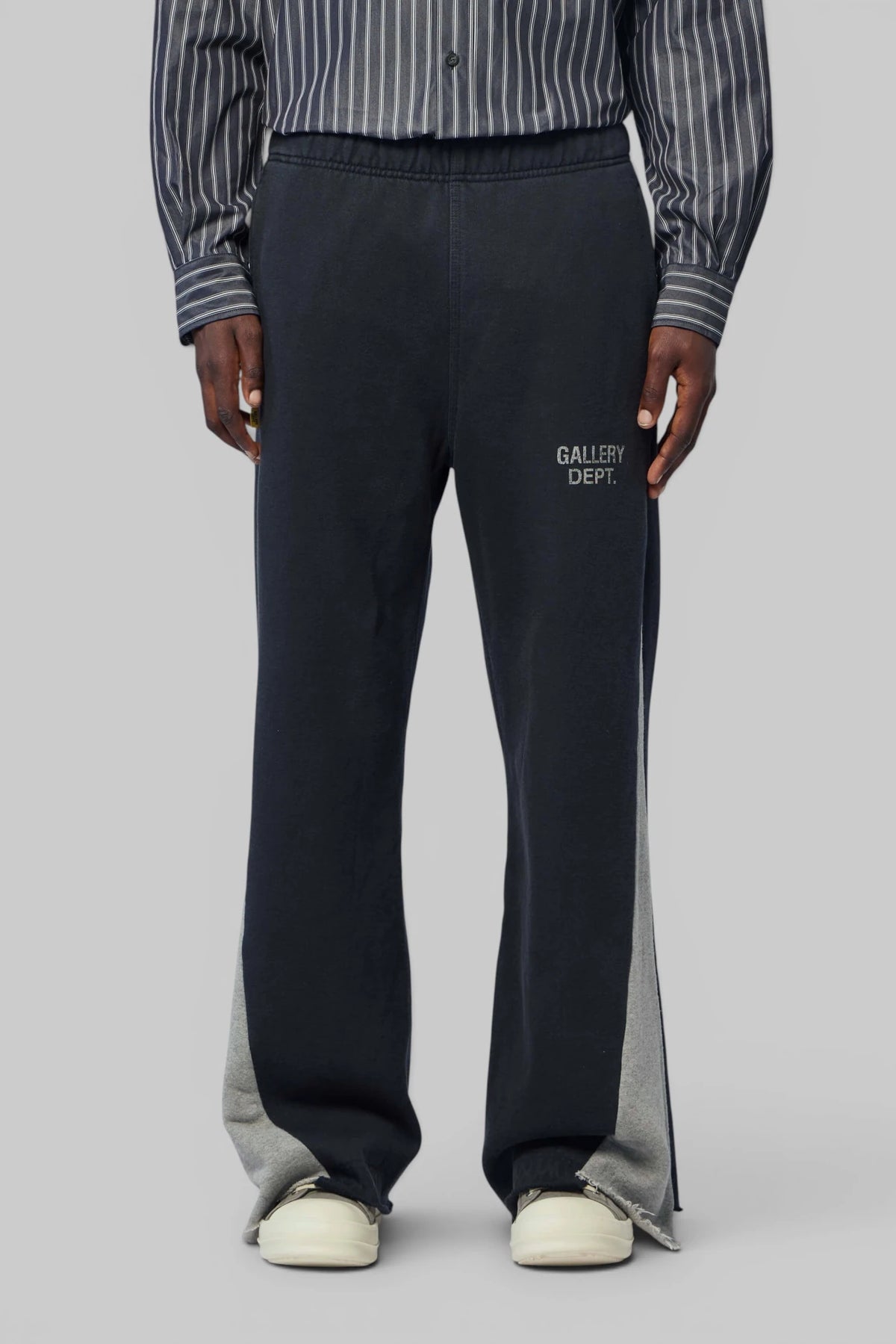 Model wearing Gallery Dept. Twisted Leg Sweatpant Flare with sneakers