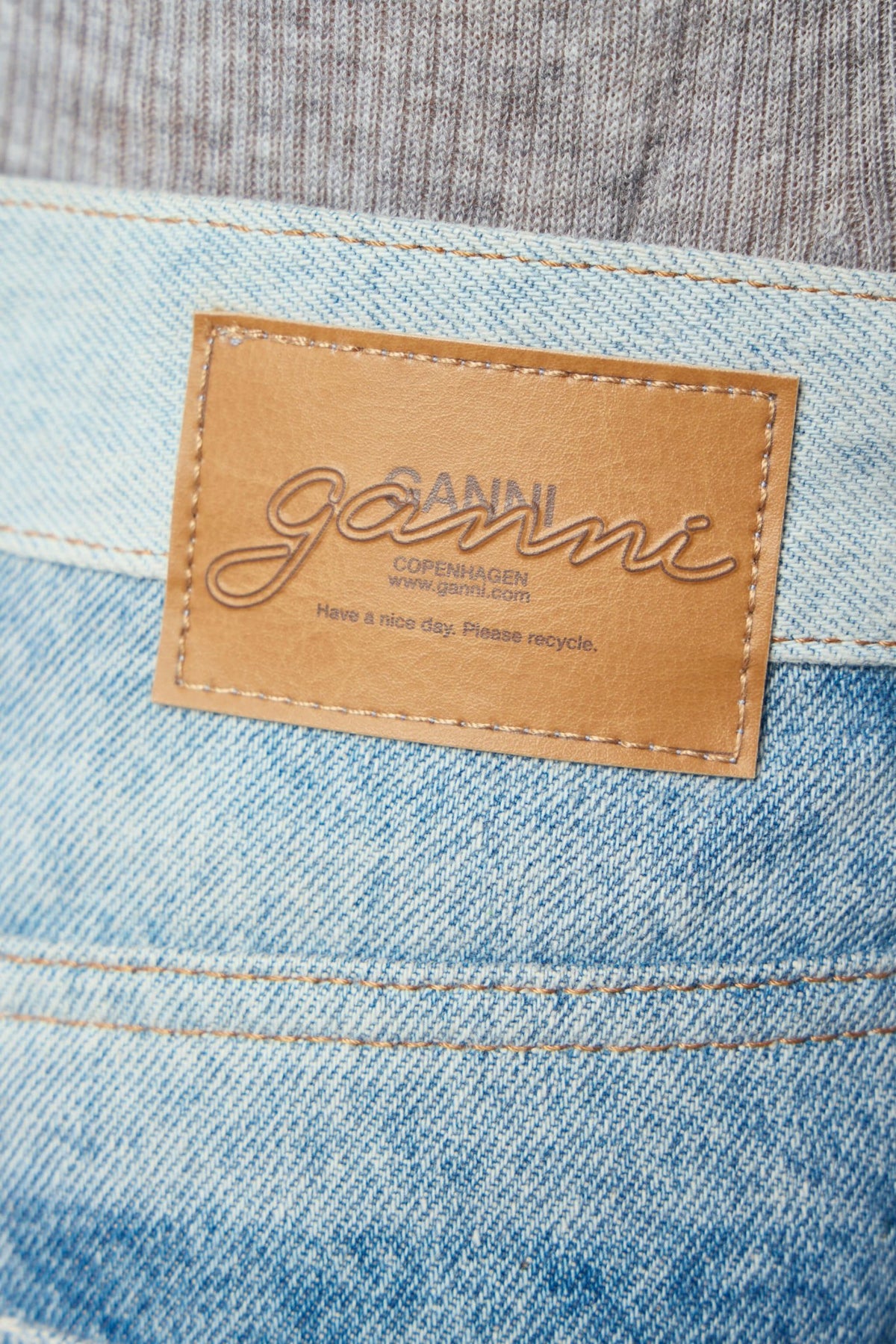 Close-up of sustainable cotton blend fabric texture on Ganni jeans
