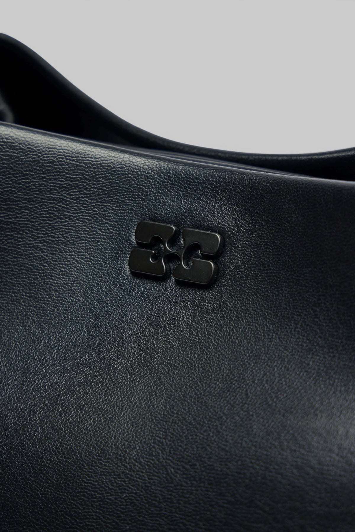 Interior view of Ganni clutch showing recycled leather lining