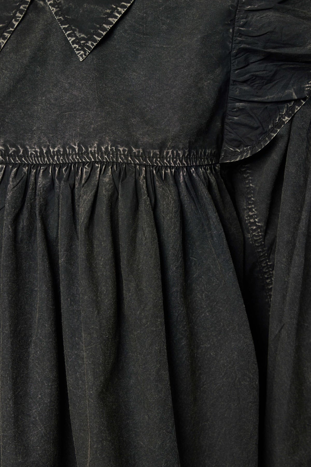 Back view of Ganni cotton blouse showcasing gathered fabric design and loose fit