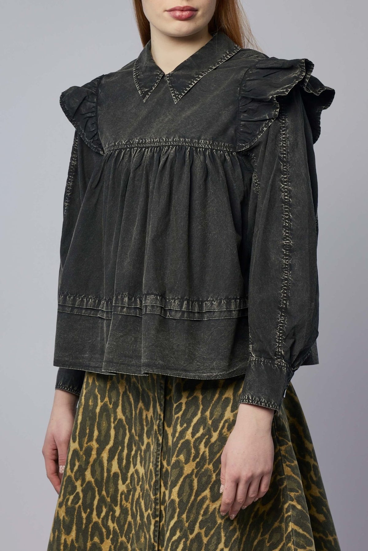 Boxy fit silhouette of Ganni garment-dyed cotton frill blouse on model