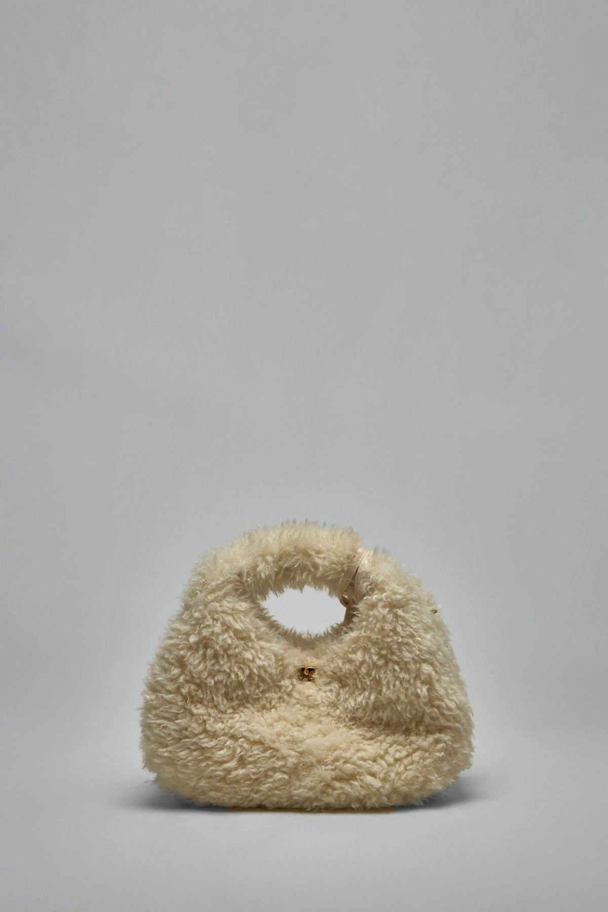 Detachable leather shoulder strap and gold-tone hardware on Ganni bag