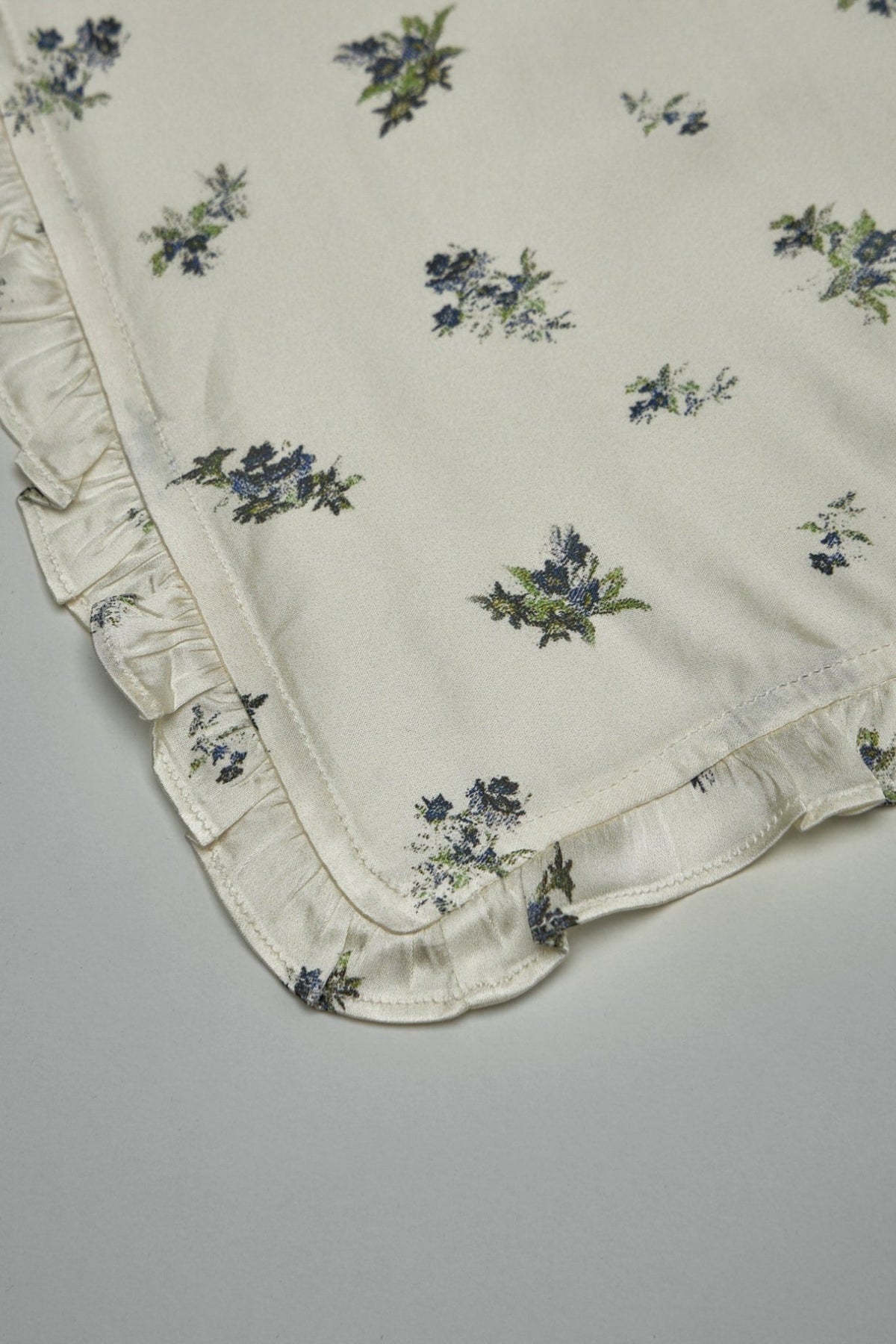 Flat lay of Ganni printed satin scarf displaying full square shape and pattern