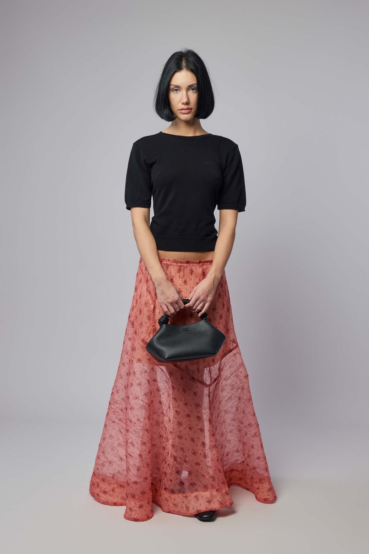 Full-length styling of Ganni shibori skirt for elegant occasions
