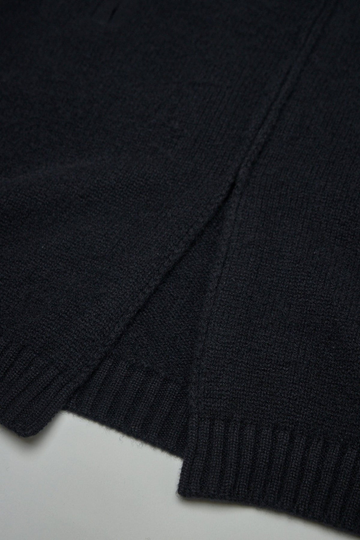 Close-up of Excella zipper and pure silk label on cashmere cardigan, view 7