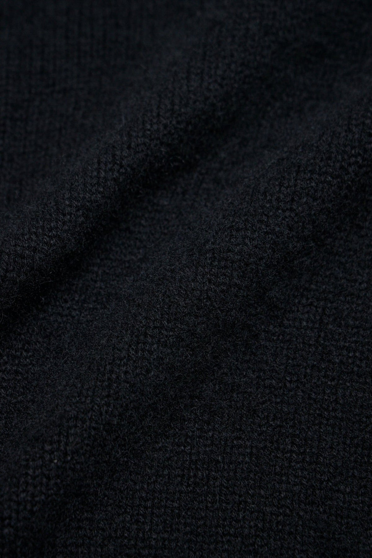 Close-up of Excella zipper and pure silk label on cashmere cardigan, view 8