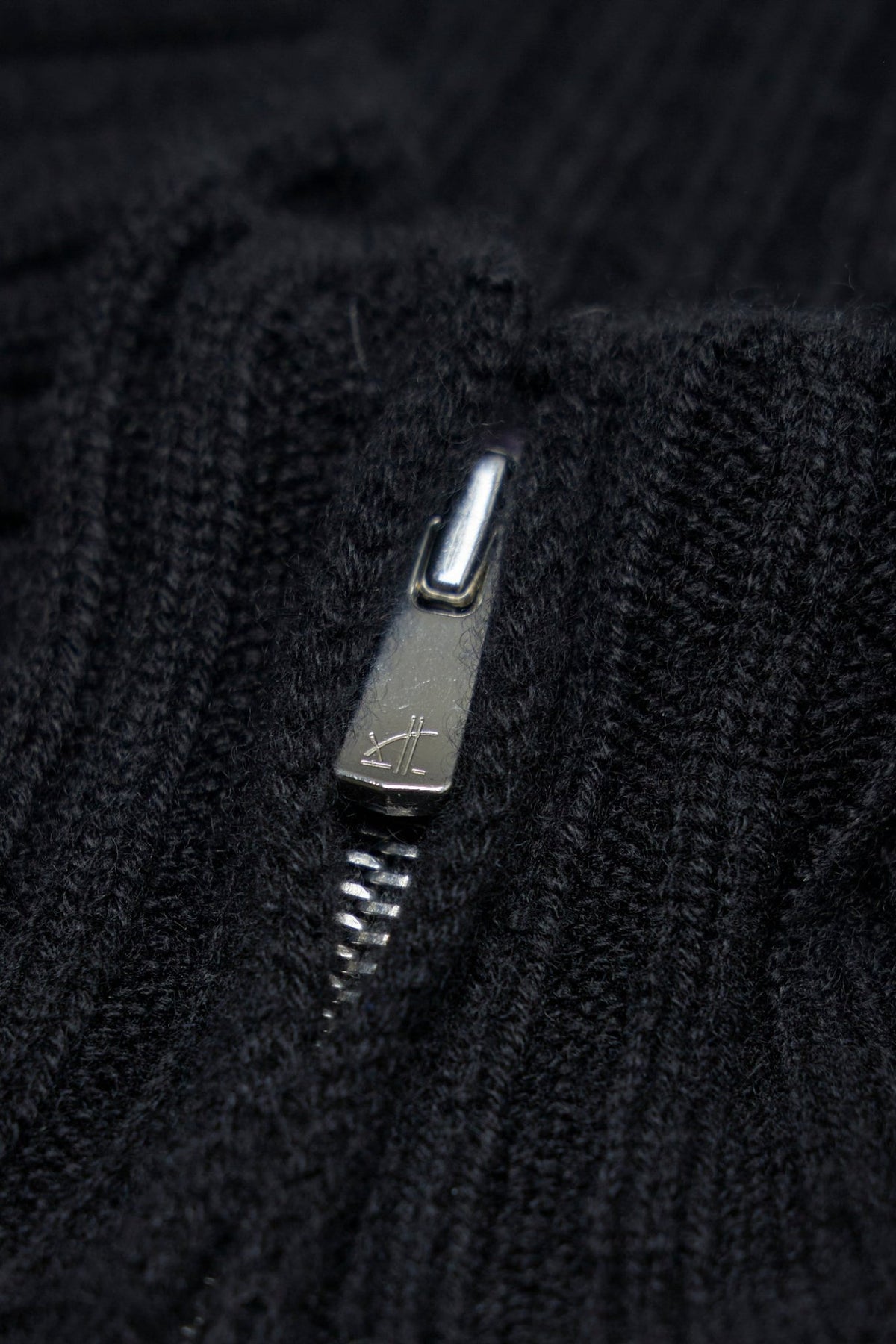 Close-up of Excella zipper and pure silk label on cashmere cardigan, view 6