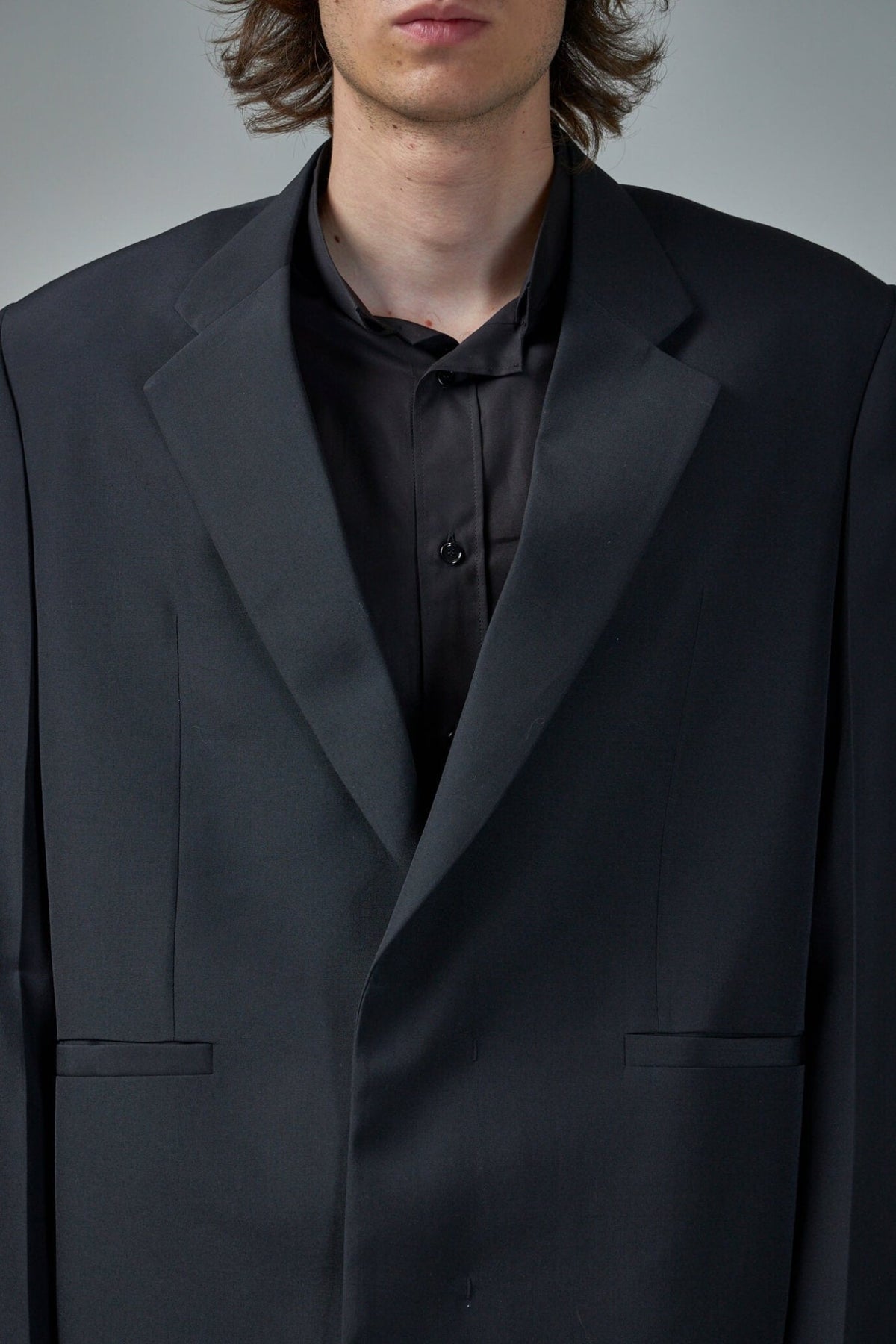 Detail shot of Givenchy blazer fabric texture and premium wool quality