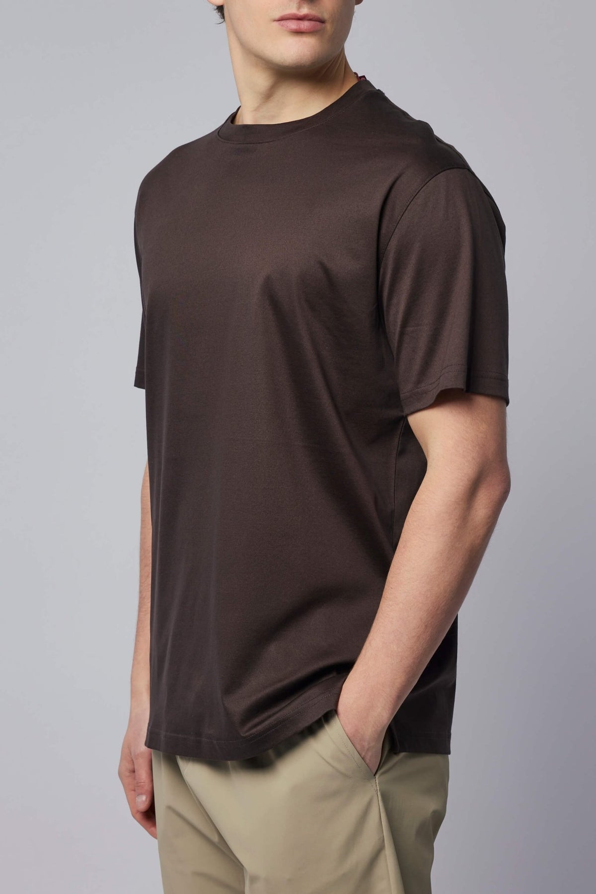 Model wearing brown Gogetti t-shirt showcasing relaxed fit and classic styling