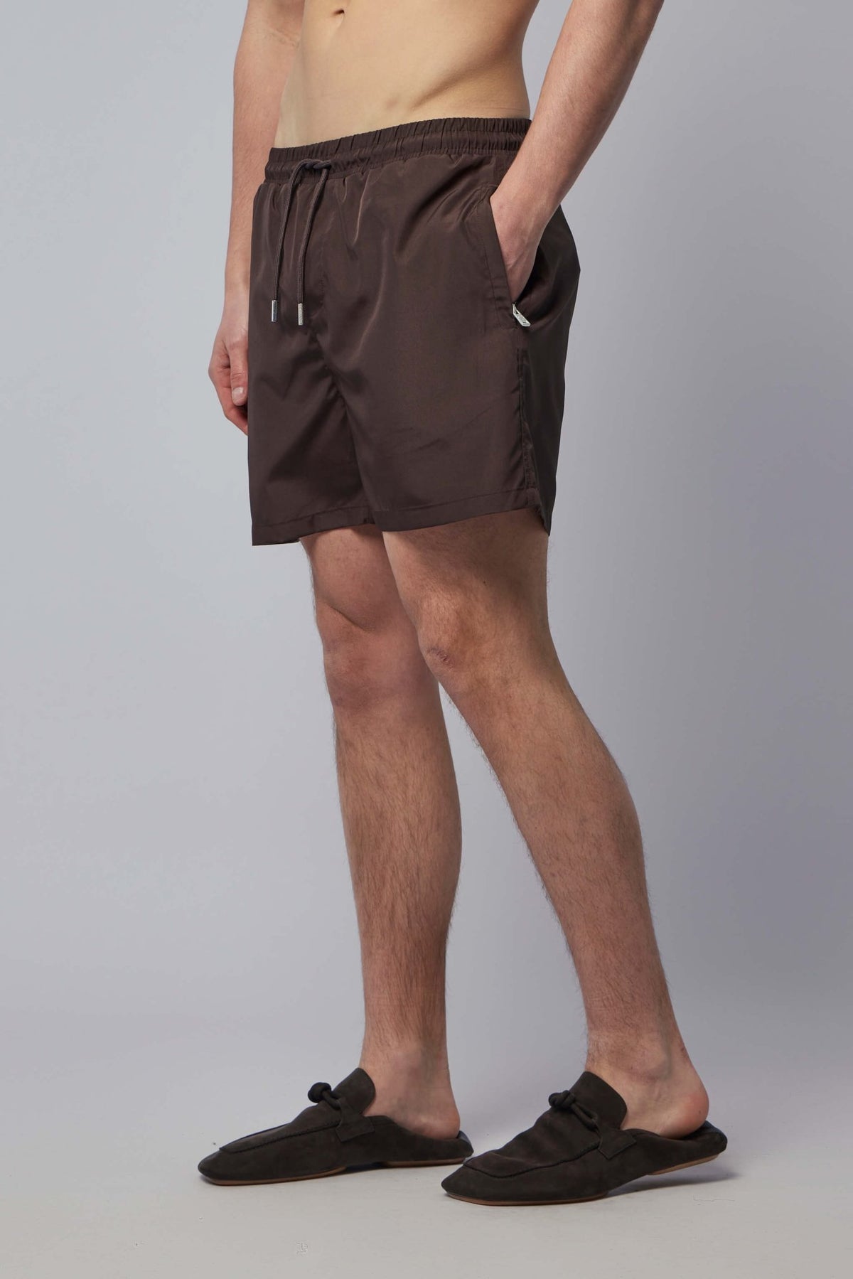 Model wearing brown Gogetti shorts showing knee-length fit