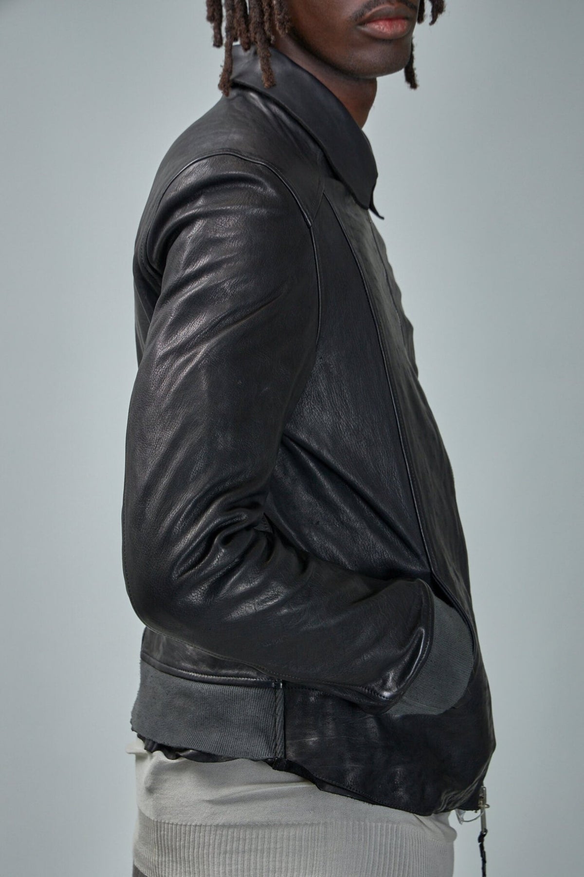 Detail shot of silver hardware and buttoned pockets on Guidi leather jacket