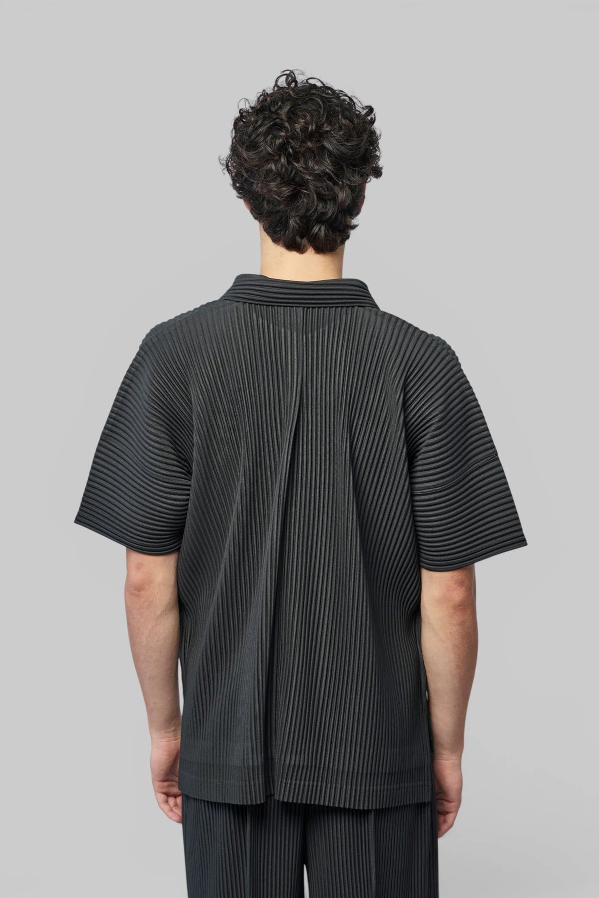 Close-up of button-up front on Homme Plissé Issey Miyake shirt