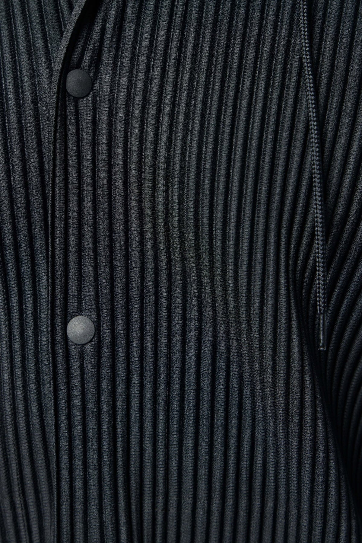 Detail shot of drawstring hood and button front closure