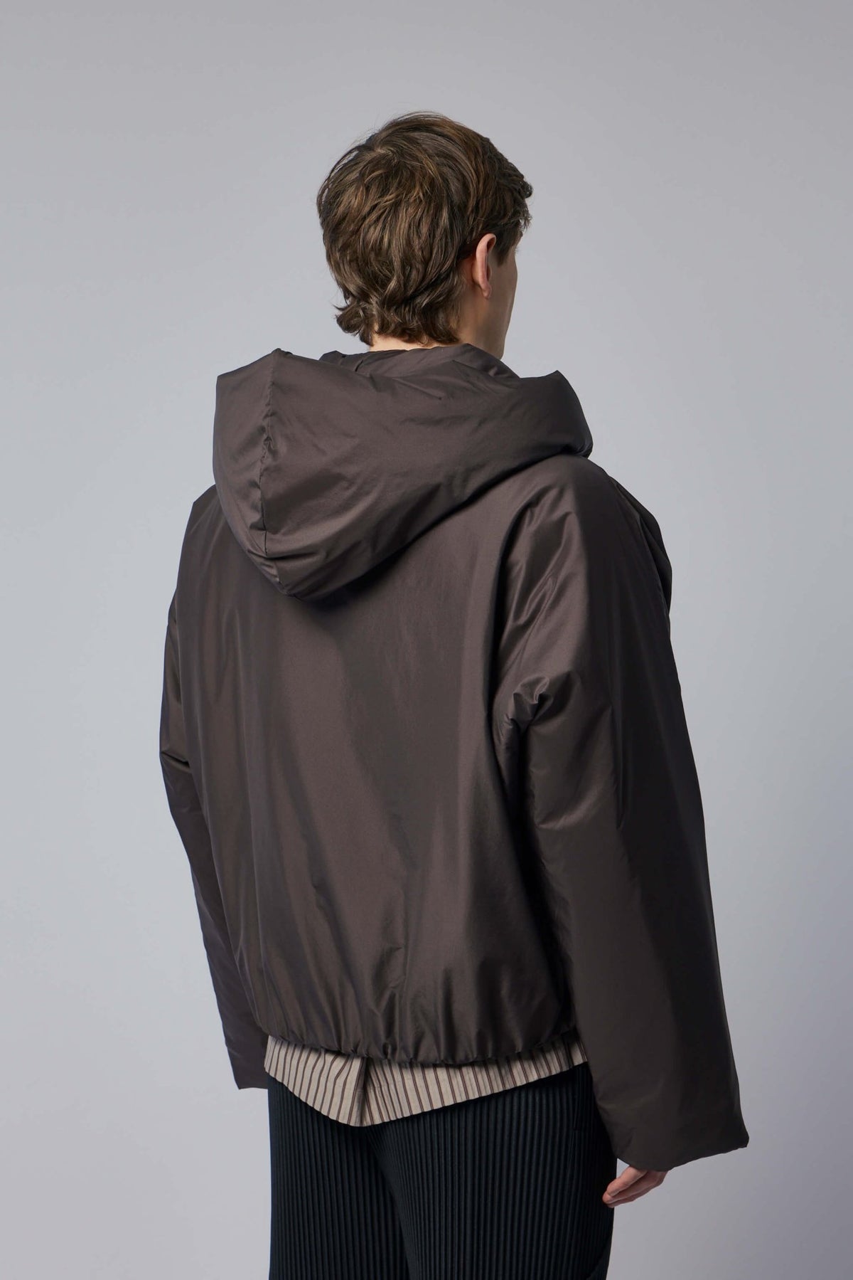 Back view showing oversized hood and clean minimalist lines