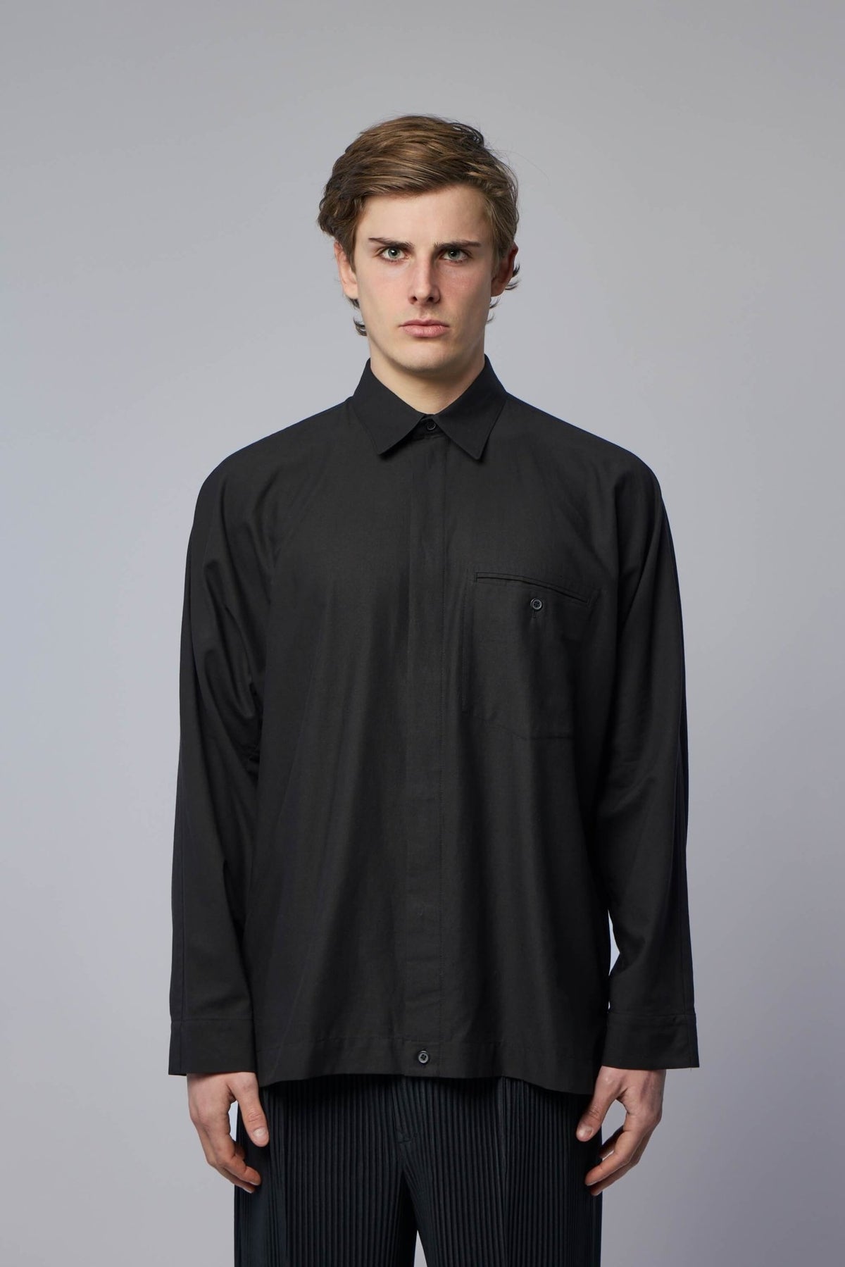 Close-up view of pleated cotton shirt texture and classic collar detail