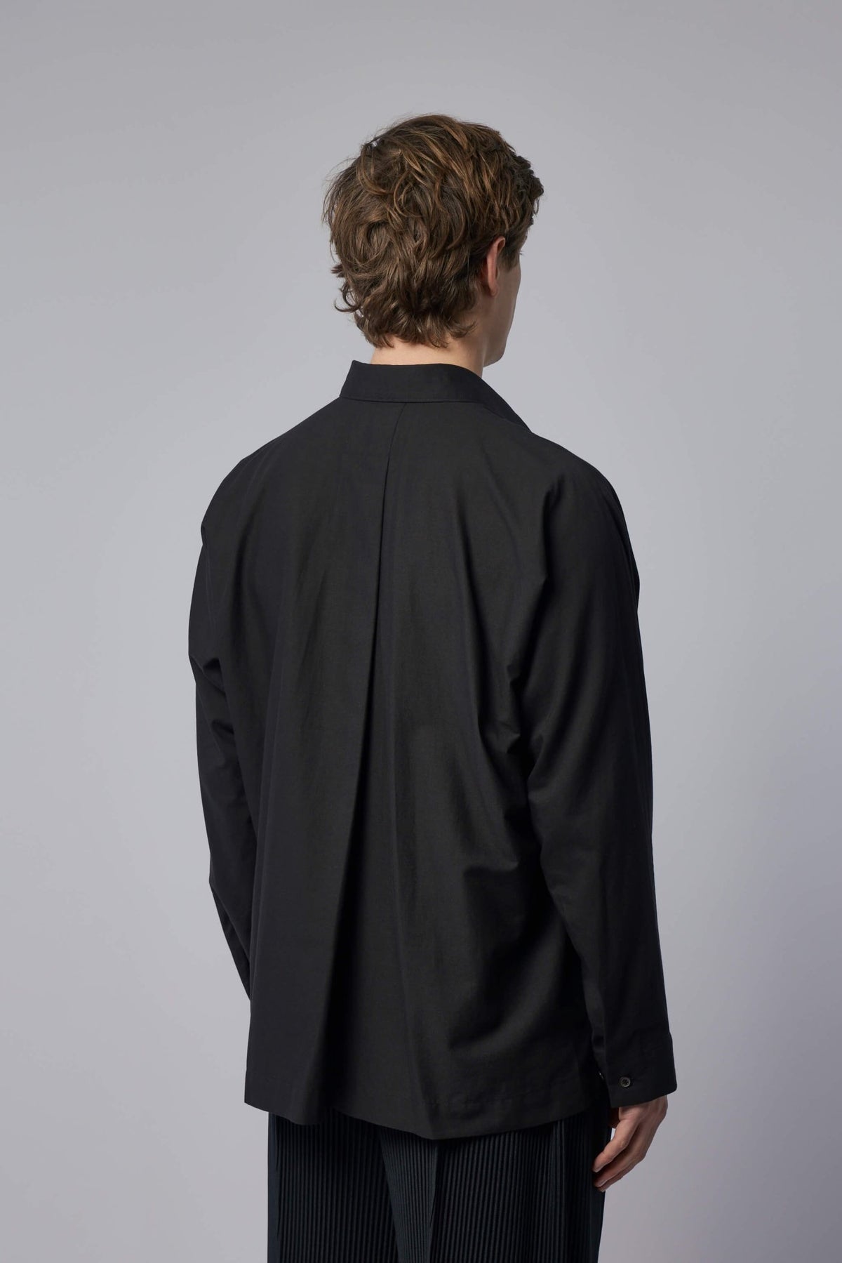 Detail shot of button closure and straight hem finish