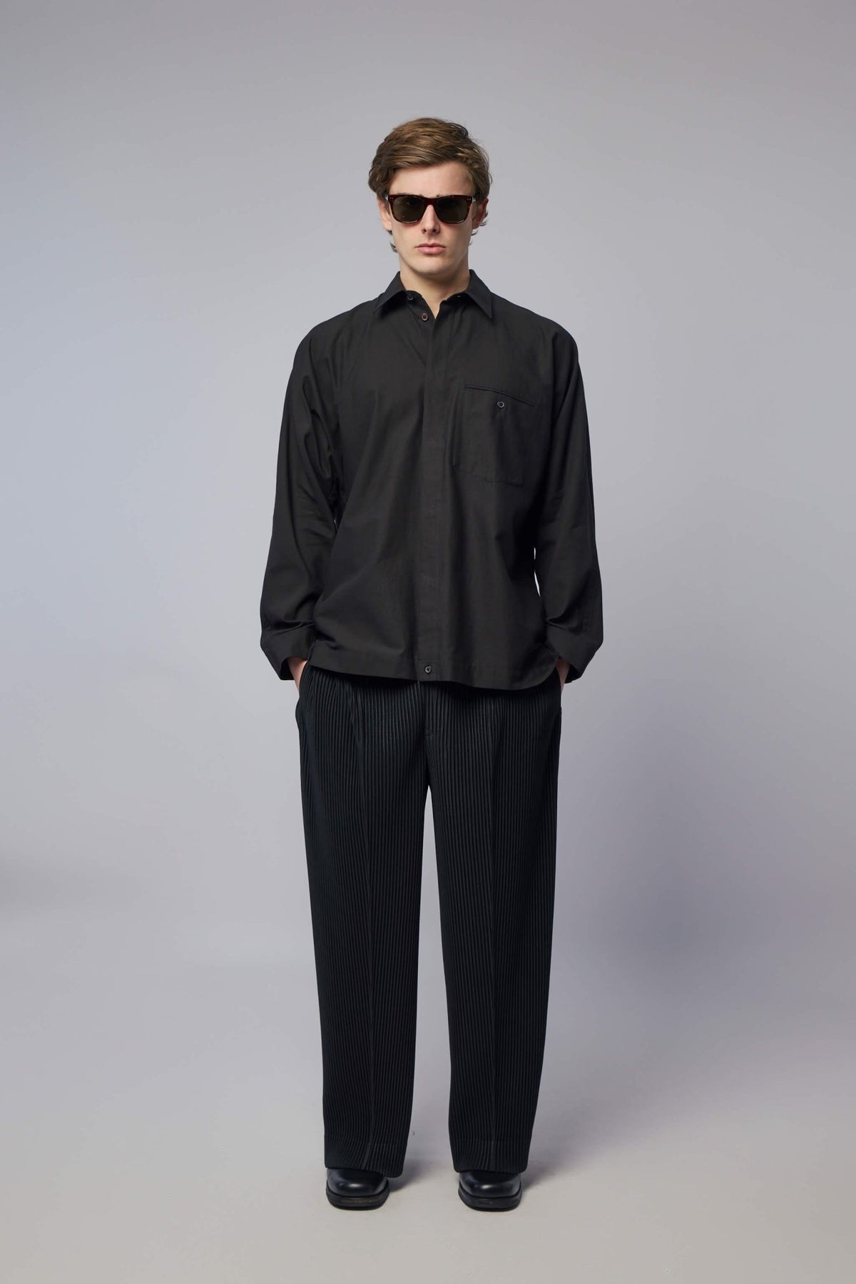 Full outfit styling with pleated shirt and coordinating pieces