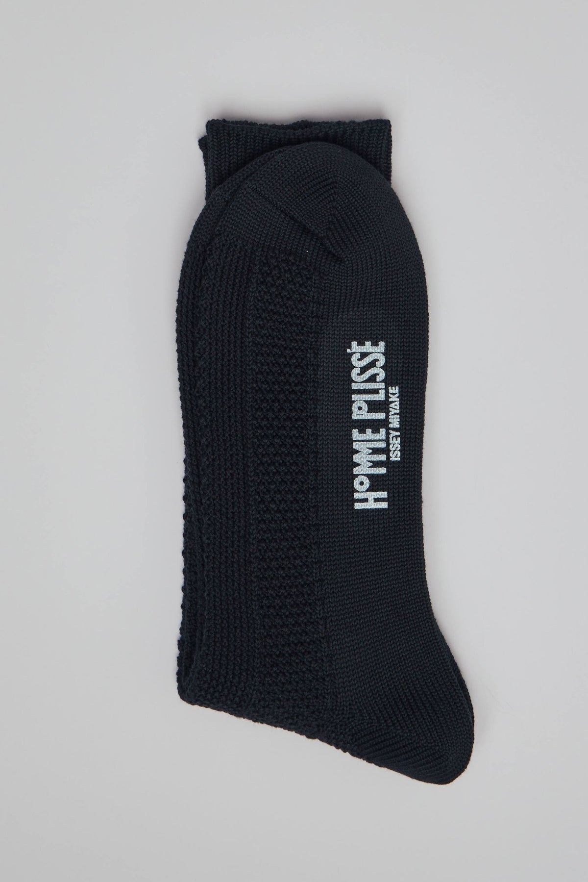 Homme Plissé Issey Miyake Socks in black with textured knit pattern and side branding