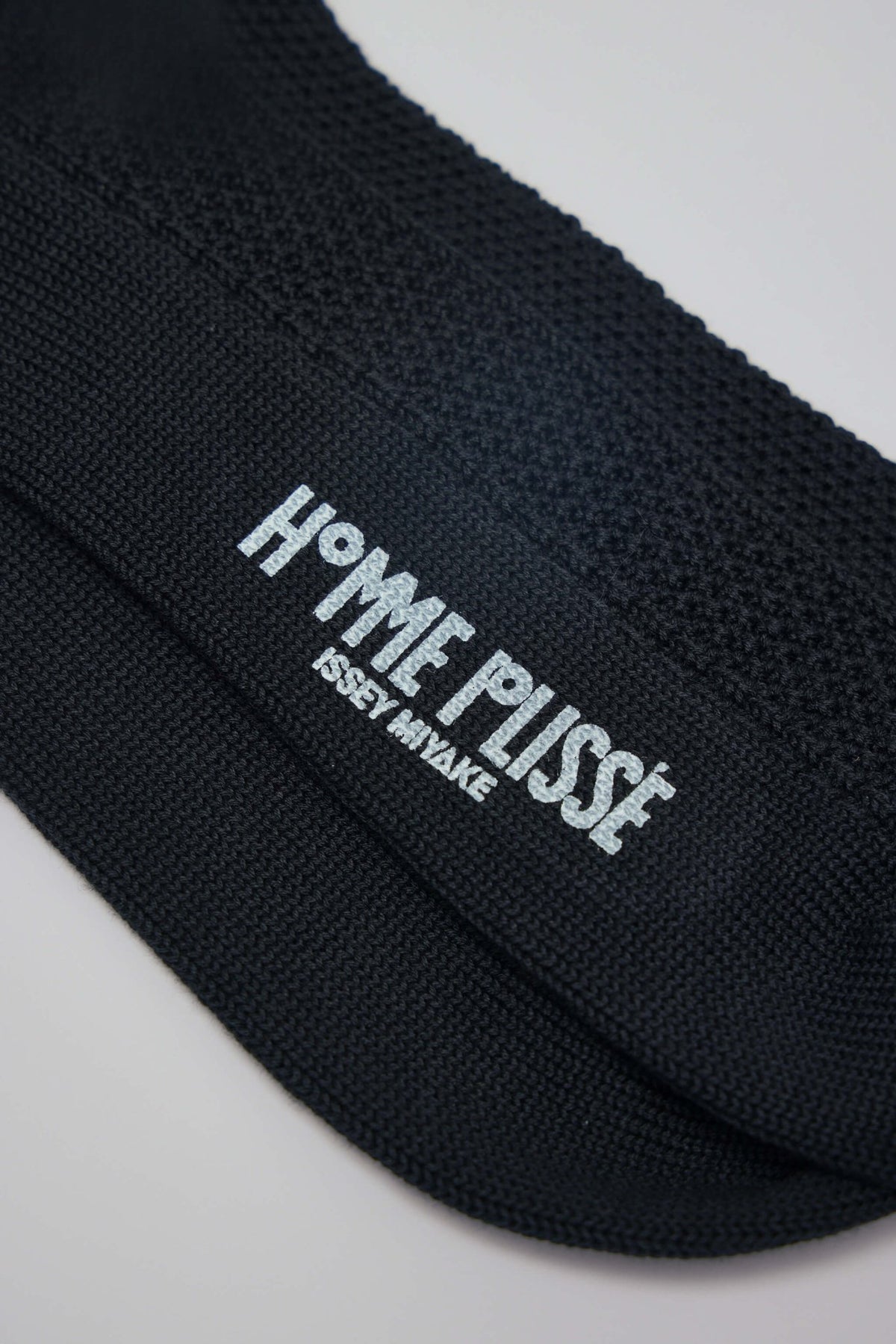 Homme Plissé Issey Miyake socks showing elastic cuffs and premium cotton construction