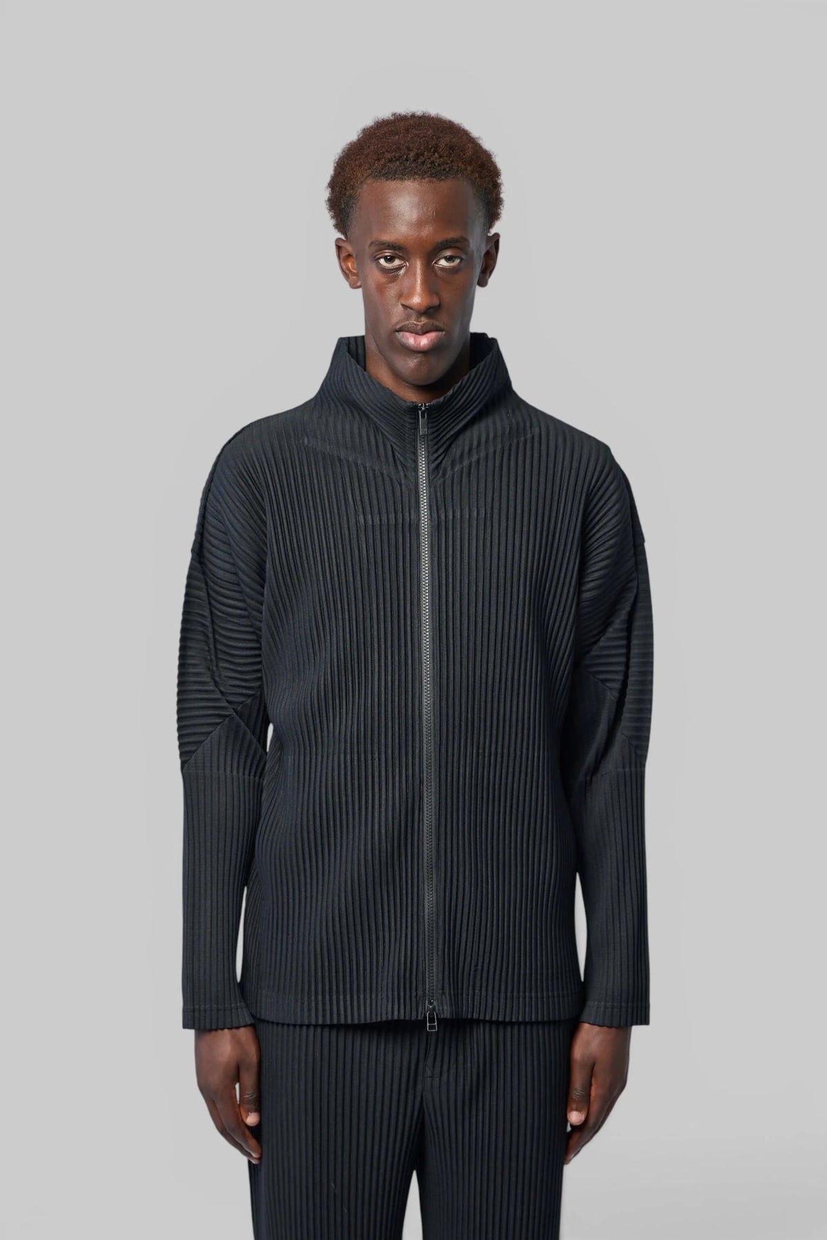 Homme Plissé Issey Miyake Zip-Ups cardigan styled with tailored trousers