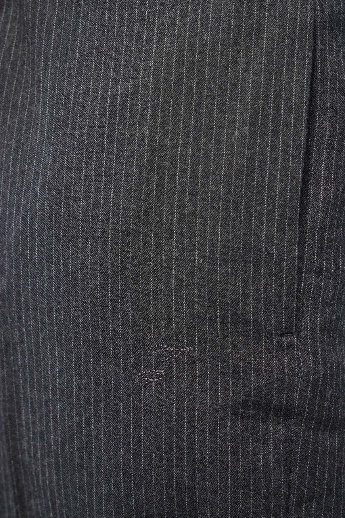 Detail shot of pinstripe pattern on Jacquemus trousers
