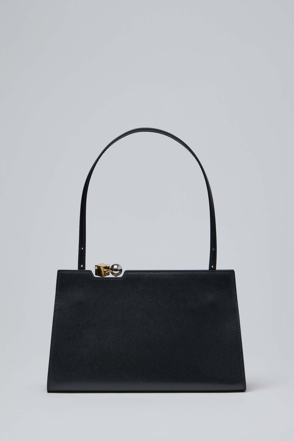 Side view of Le Salon bag showing rectangular shape and smooth leather finish