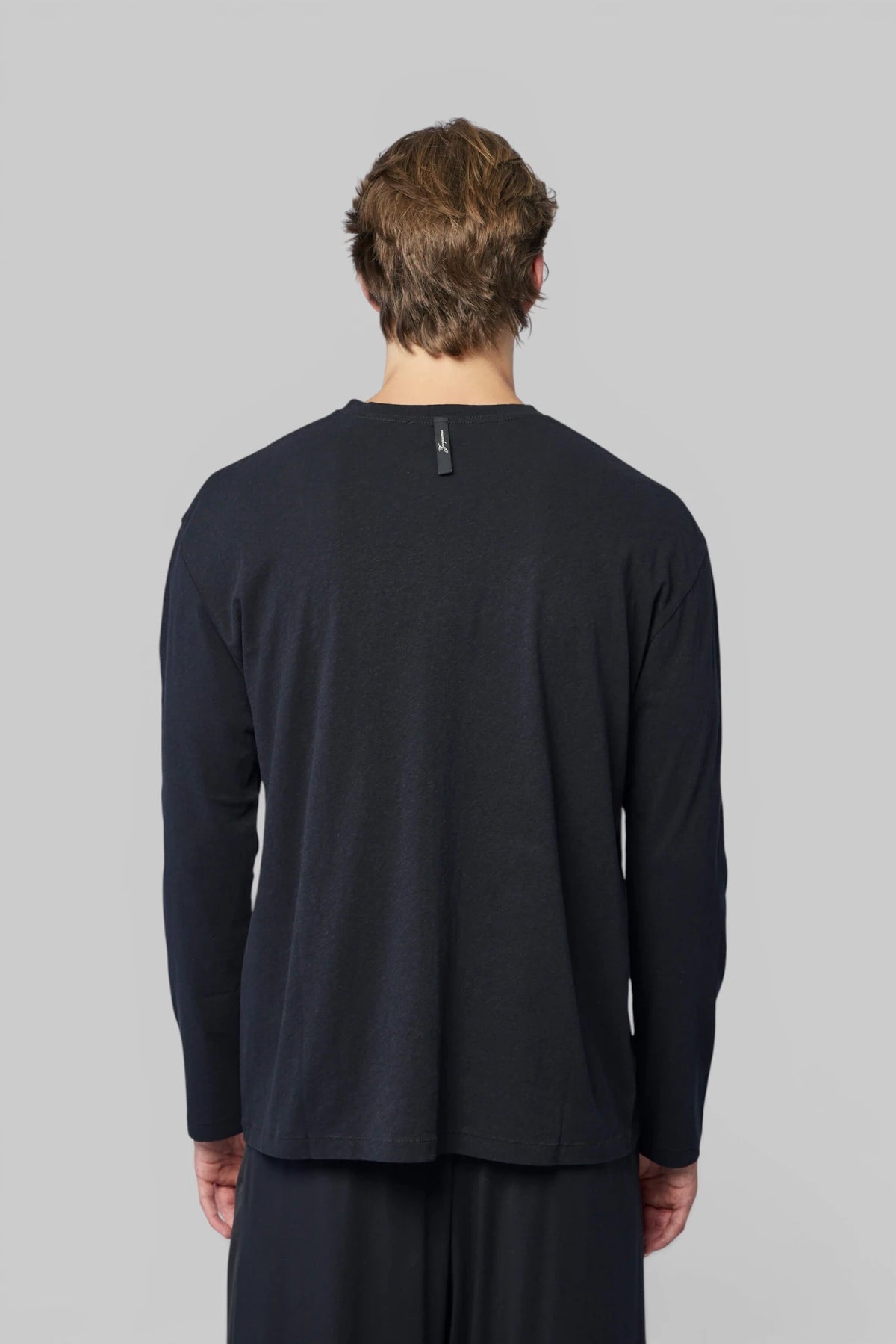 Jacquemus sweatshirt styled with tailored trousers for a smart-casual look