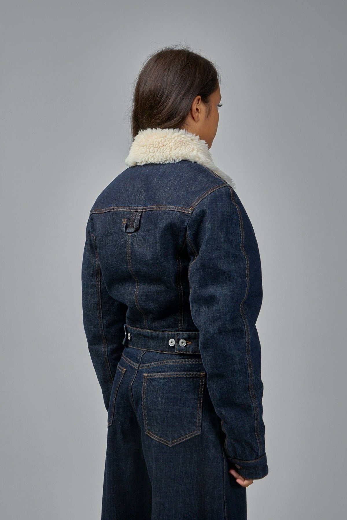 Back view showing adjustable tab detail on Jacquemus denim jacket