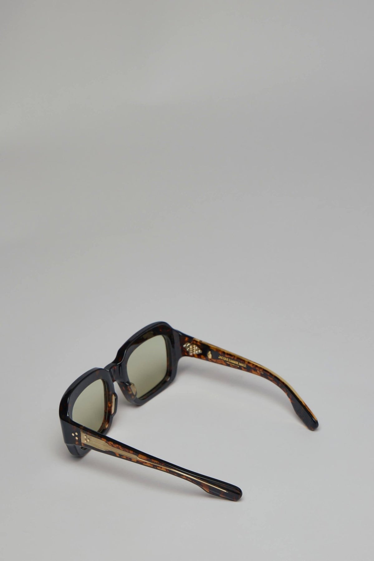 Jacques Marie Mage sunglasses displayed on neutral background showing lens gradient