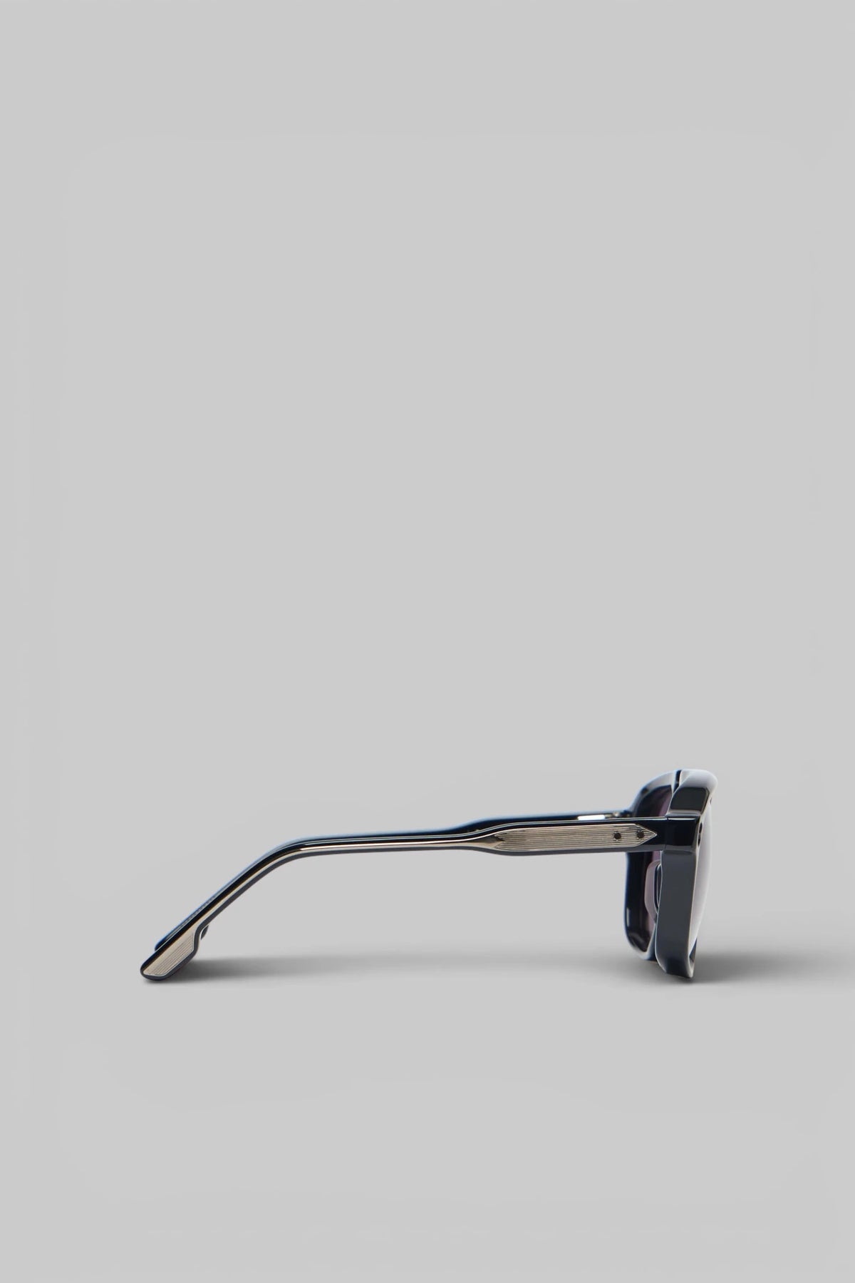 Close-up view of Leonard sunglasses showing distinctive bridge design and metallic temple accents