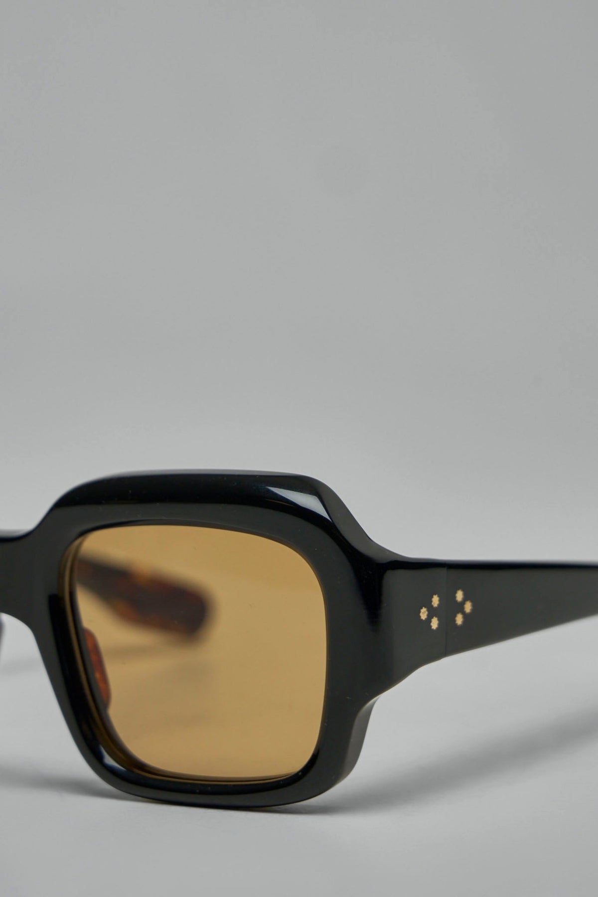 Premium sunglasses displayed against neutral background showcasing craftsmanship, view 5