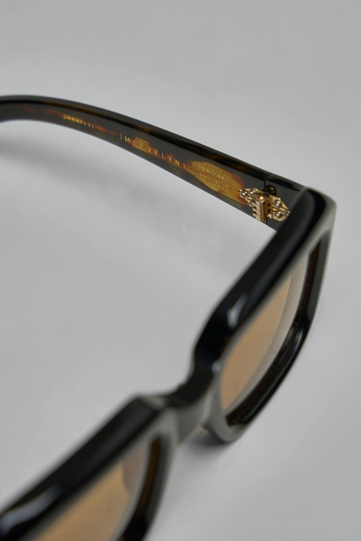 Premium sunglasses displayed against neutral background showcasing craftsmanship, view 6