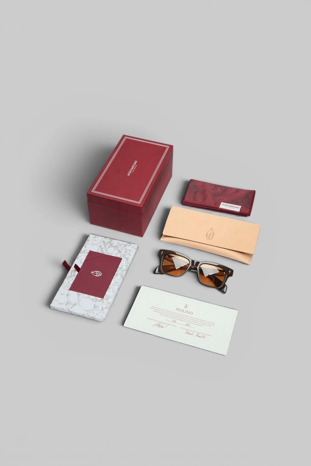 Jacques Marie Mage Molino sunglasses styled on a flat surface