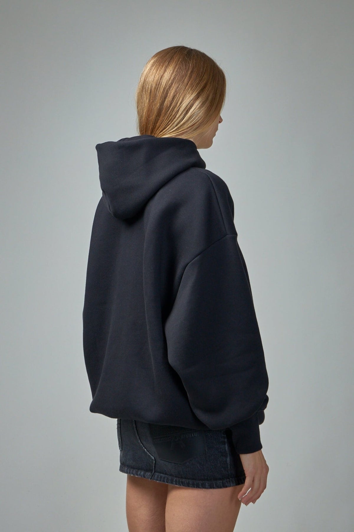 Model wearing oversized Jean Paul Gaultier cotton hoodie with drawstring hood