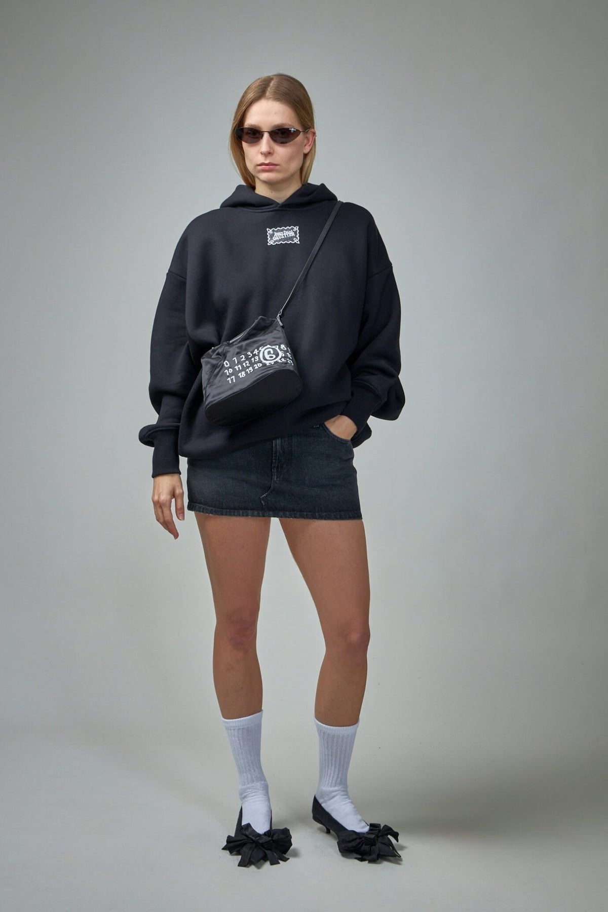 Close-up of Jean Paul Gaultier lace label on cotton hoodie front