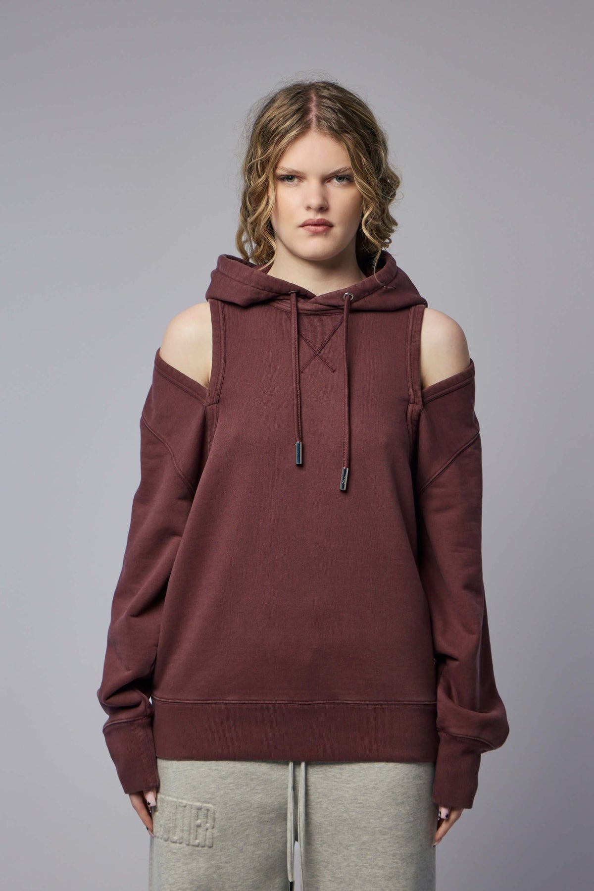 Close-up of unique open shoulder detail on luxury hoodie
