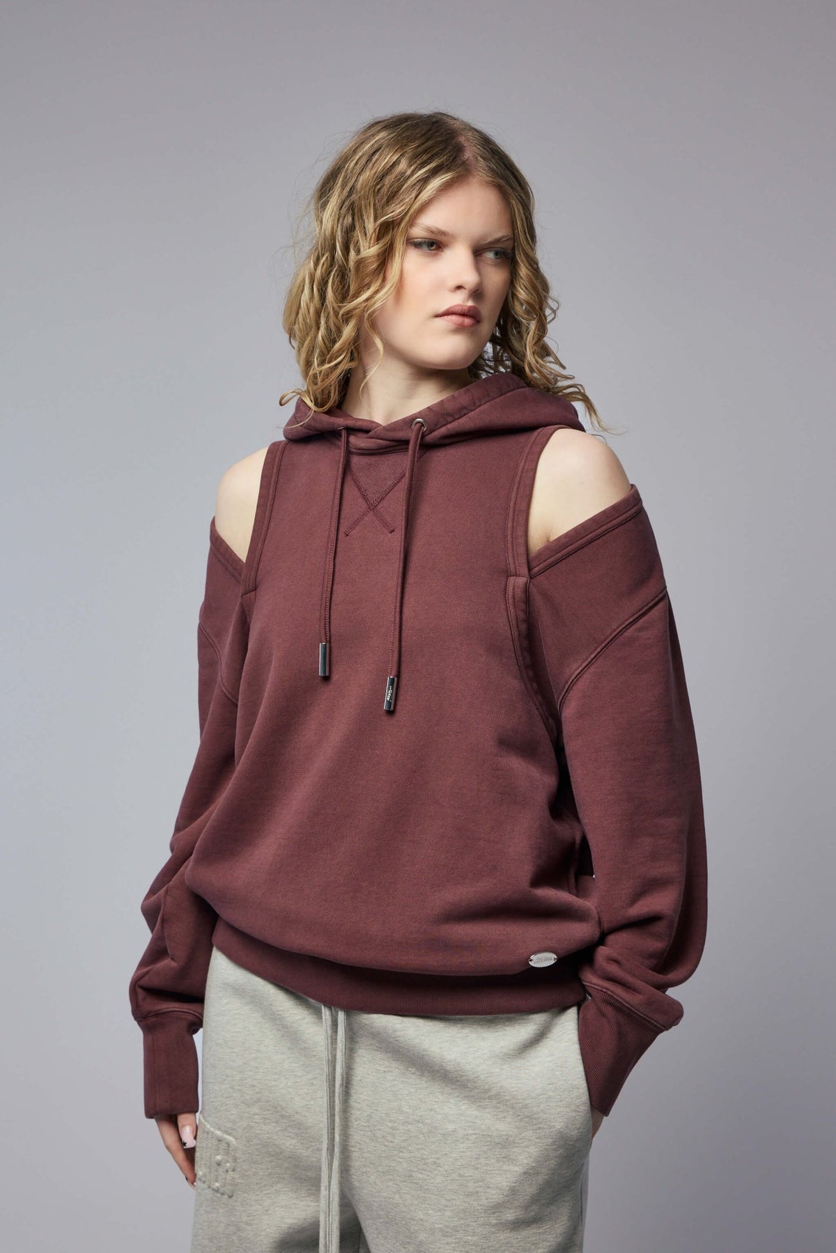 Model wearing Jean Paul Gaultier French terry hoodie with deconstructed design